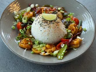 Spice up your dinner in just 20 minutes with Chef Shiyas Kareem’s Firecracker Prawns. This vibrant dish features succulent prawns and vegetables in an explosive firecracker sauce.