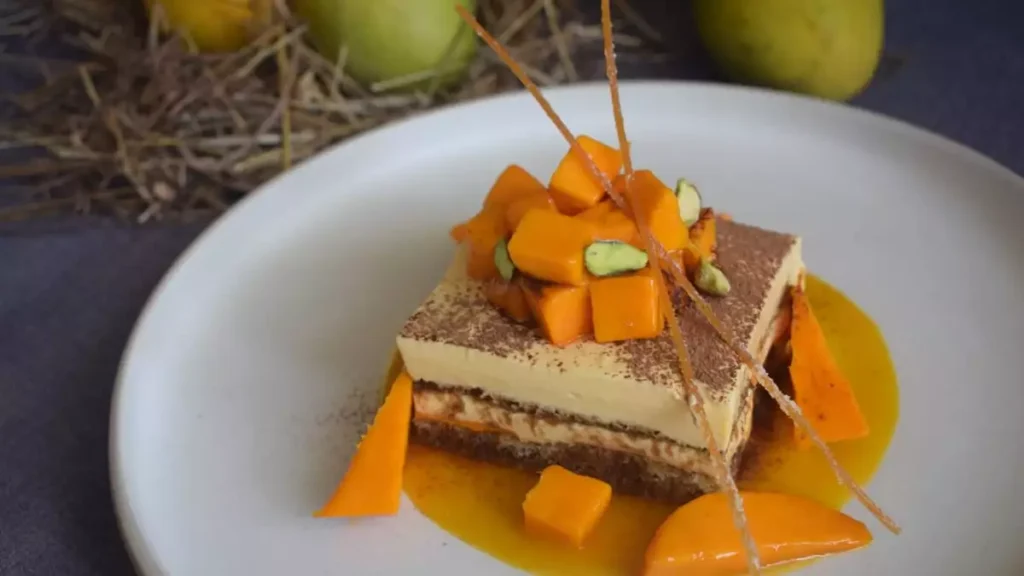 mangomisu recipe Italian dessert tiramisu with mango tropical twist Chef Anant Bansode Four Points By Sheraton Navi Mumbai Vashi high-quality mascarpone cheese fresh Alphonso mangoes savoiardi ladyfingers espresso coffee syrup Kahlua liquor optional luxurious treat refreshing dessert layers of ladyfingers mango pulp dessert recipe easy recipe cook time preparation time how to make mangomisu mascarpone cream cooking instructions dessert garnished with cocoa powder mango slices special occasion dessert Italian-inspired treat rich flavors
