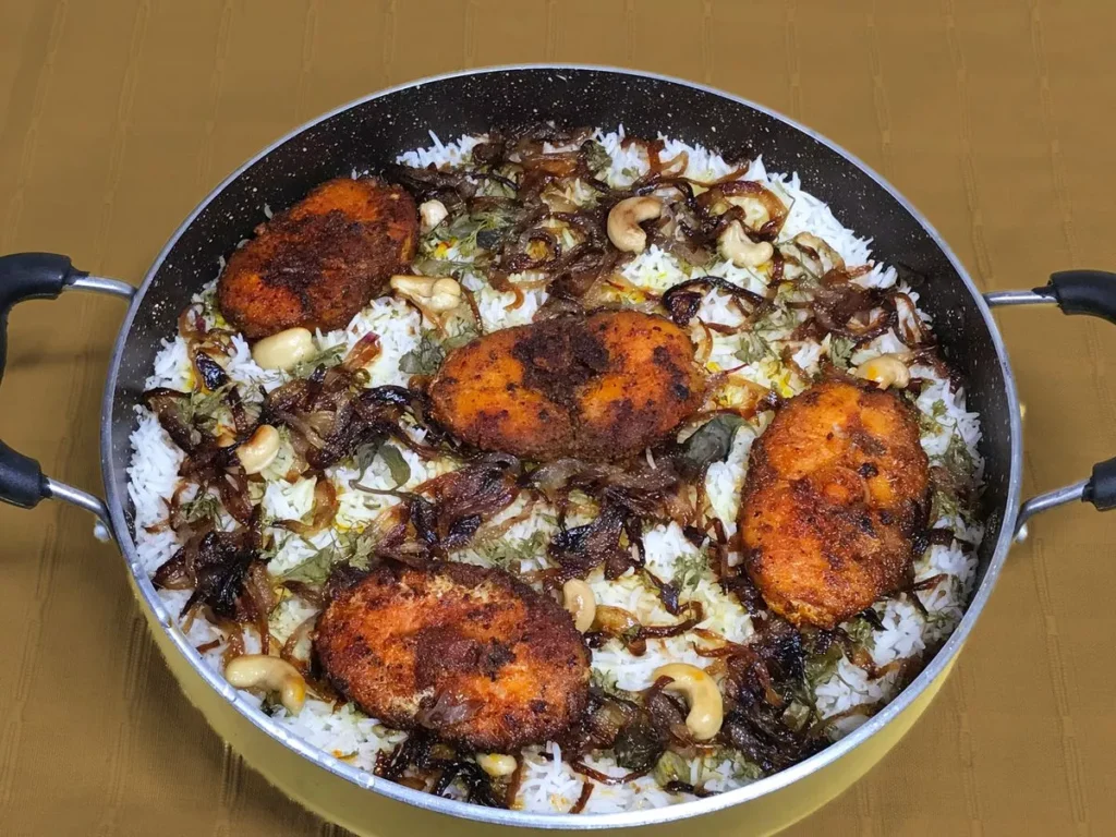 restaurant-style fish biryani recipe fragrant spiced rice flaky fish fillets Indian cuisine weekend feast Sobha Varghese Sobha's Kitchenette Kerala recipes authentic traditional cooking YouTube blog popular recipe aromatic Indian spices basmati rice Kashmiri red chilli black