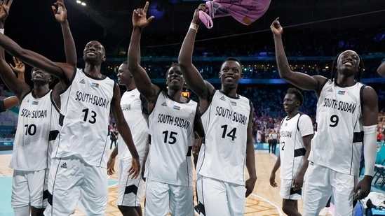 Paris Olympics anthem mistake South Sudan basketball team first Olympic victory South Sudan independence 2011 South Sudan Puerto Rico basketball game Lille Pierre Mauroy Stadium Royal Ivey coach Nuni Omot forward anthem mix-up unity resilience historical win Olympic debut national anthem error sports news global sports event athlete pride solidarity competitive sports basketball triumph team spirit overcoming challenges international sports tournament sportsmanship Olympic achievement African nation sports history
