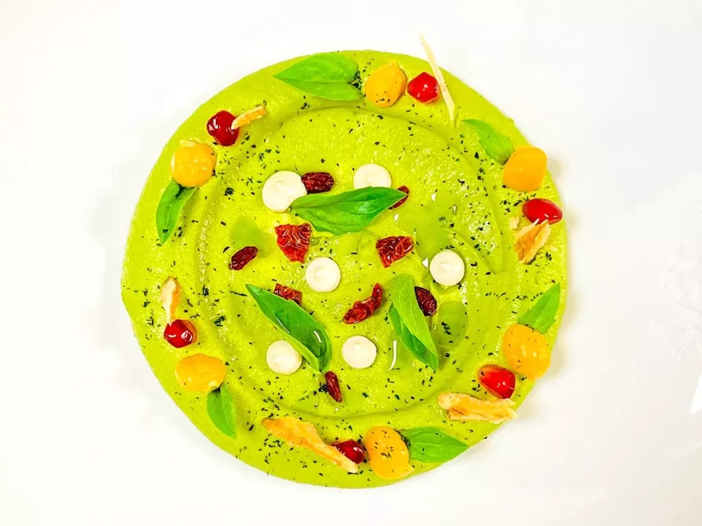 vegan gluten-free basil hummus recipe quick healthy snack Chef Mayssam Abdulkhalek Gulf News delicious healthful snack option easy-to-make dip hassle-free preparation boiled chickpeas white tahini lemon juice cherry tomatoes olive oil basil Himalayan pink salt pine nuts mint sprigs garnish