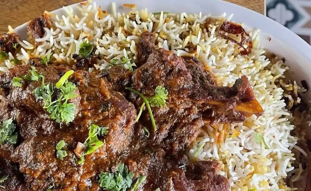 Nalli Gosht Biryani Recipe Step-by-Step Guide NDTV Food Aromatic Spices Lamb Shanks Basmati Rice Ghee Onion Cooking Time Indian Cuisine Traditional Dish Yoghurt Mint Leaves Coriander Leaves Black Cumin Seeds Bay Leaves Almonds Raisins Garam Masala Turmeric Ginger Garlic Paste Whole