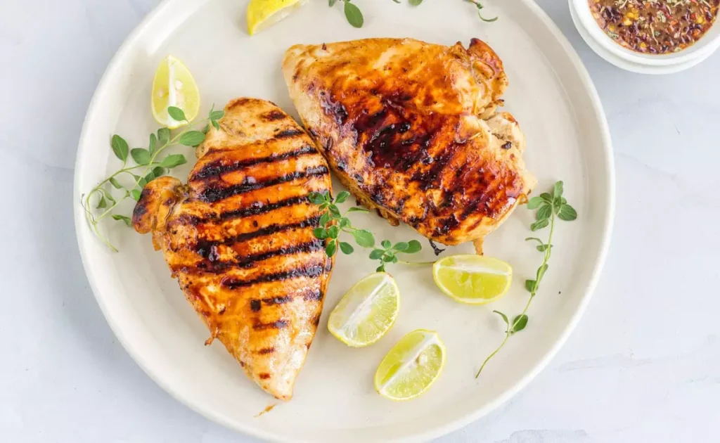 spicy grilled chicken recipe chef Bhushan Ganorkar DoubleTree by Hilton Goa Panaji harissa marinade mango salsa sautéed broccoli dinner parties easy recipe cooking time preparation time healthy recipes grilled chicken thighs boneless chicken breasts mango salsa ingredients harissa paste roasted red peppers date syrup caraway seeds coriander powder cumin powder smoked paprika cayenne pepper kosher salt extra virgin olive oil lime juice cilantro leaves jalapeño red bell pepper red onion parsley chopped broccoli florets sautéed broccoli recipe steps food processor chicken marinade vibrant mango salsa dinner gathering meal preparation time easy cooking healthy meal spicy chicken dish flavorful recipe