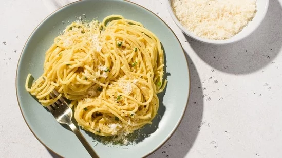 Amalfi lemon pesto pasta recipe lemon zest almonds Parmesan cheese olive oil coastal Italy citrusy pasta Milk Street cookbook Amalfi Coast traditional pesto lemon-scented spaghetti al dente food processor lemon zest strips slivered almonds grated Parmesan fresh chives aromatic pesto easy pasta dish Italian cuisine seafood lemons Mediterranean flavors homemade pesto pasta cooking water lemony notes culinary delight zest removal kosher salt ground black pepper vegetable peeler long zest strips boiling pasta water balance acidity touch of sugar pasta water perfume light flavor