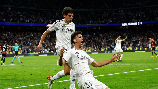 Real Madrid Mallorca La Liga 2025 Jacobo Ramon last minute goal Real Madrid vs Mallorca Kylian Mbappe Real Madrid victory Barcelona title delayed Real Madrid comeback La Liga title race Mbappe league goals Mbappe vs Lewandowski El Clasico 2025 Real Madrid vs Barcelona Real Madrid Santiago Bernabeu La Liga standings Barcelona vs Espanyol Carlo Ancelotti Brazil coach Ancelotti farewell Real Madrid manager Xabi Alonso Bayer Leverkusen La Liga final rounds Spanish