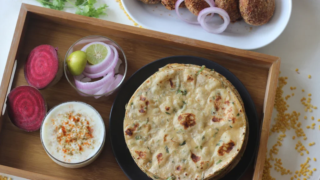 Rajasthani moong dal paratha moong dal paratha recipe crispy paratha Indian flatbread traditional paratha Rajasthani recipe healthy breakfast Indian snack easy paratha recipe whole wheat flour atta dhuli dal soaked dal green chili cumin seeds jeera fennel seeds nigella seeds kalonji garam masala red chili powder turmeric powder haldi asafoetida hing coriander leaves fresh coriander oil ghee cooking tips flatbread recipe