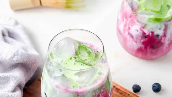 festive season bloating breakfast drinks Harvard approved Dr Saurabh Sethi unsweetened matcha latte berry almond smoothie creamy spiced lassi reduce bloating morning energy healthy drinks detox drinks for bloating anti bloat beverages festive mornings light breakfast drinks matcha powder almond milk oat milk Greek yogurt raspberries blueberries smoothie recipe lassi recipe cardamom saffron nuts ice cubes curd healthy breakfast drinks detox smoothie morning wellness drinks bloating remedies quick breakfast drinks easy morning drinks healthy lifestyle Dr Sethi tips digestive health festive wellness morning detox beverages